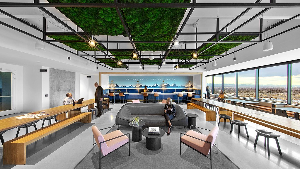 A group of people in a room with a large window.